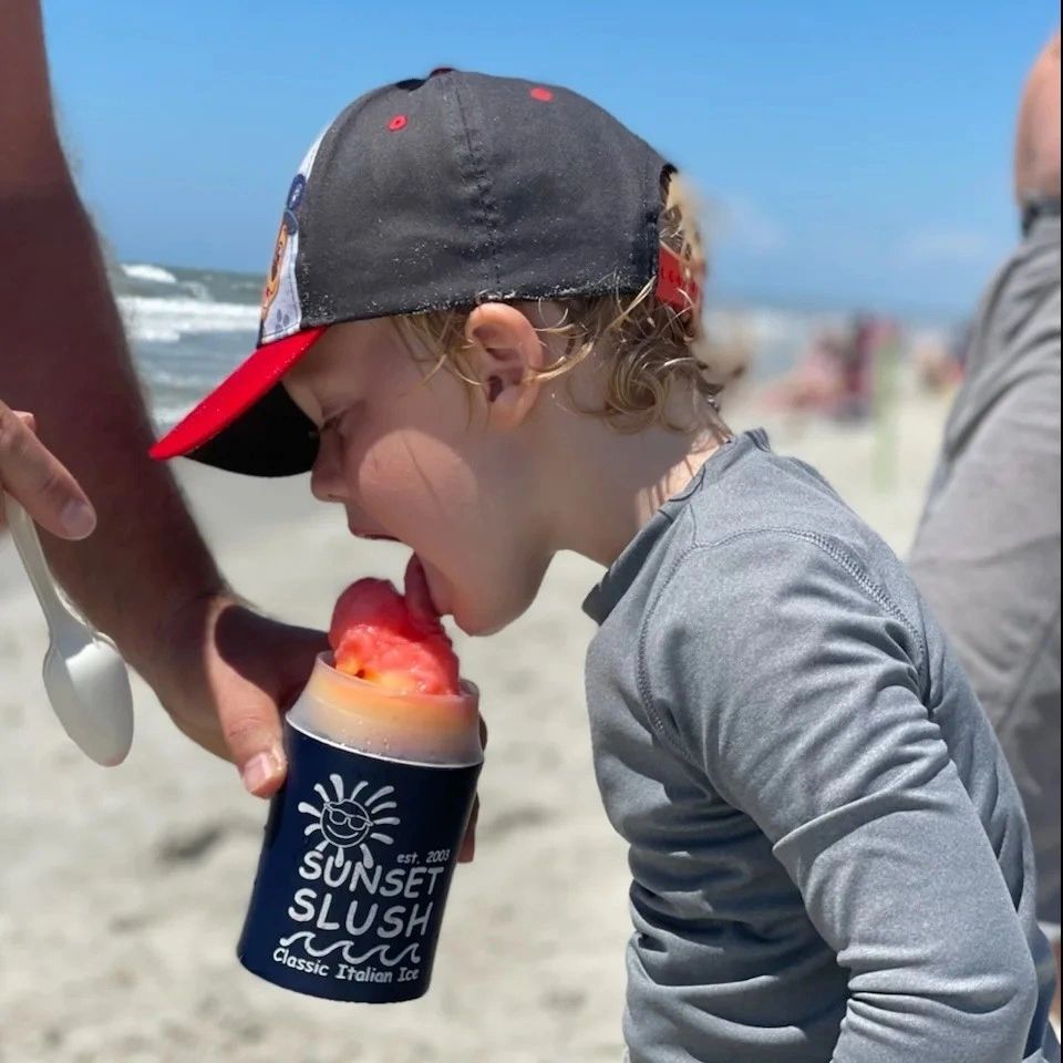Child enjoying Italian ice at the beach