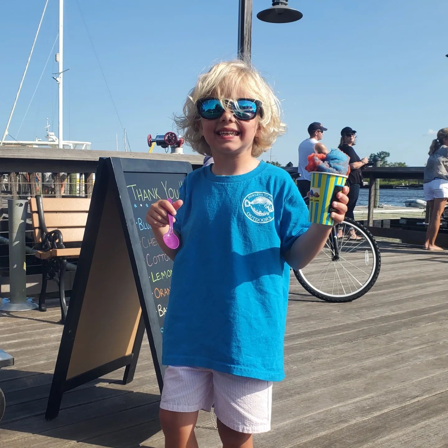 Child on boardwalk with Italian ice